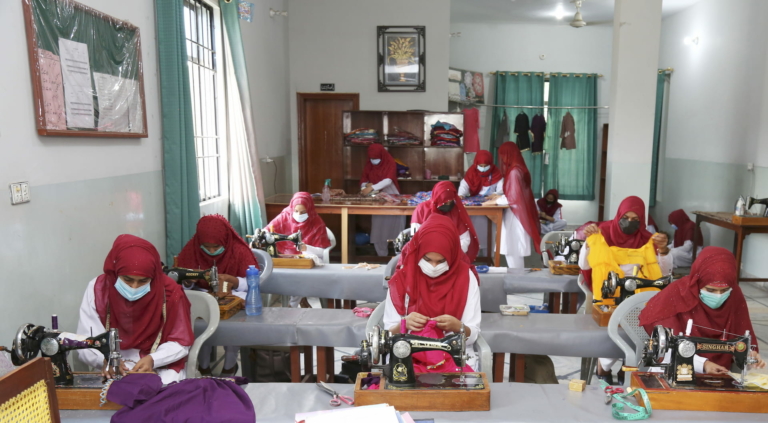 Women at the Al-Zohra Sadiq Vocational Institue learning sewing to help the, with employment