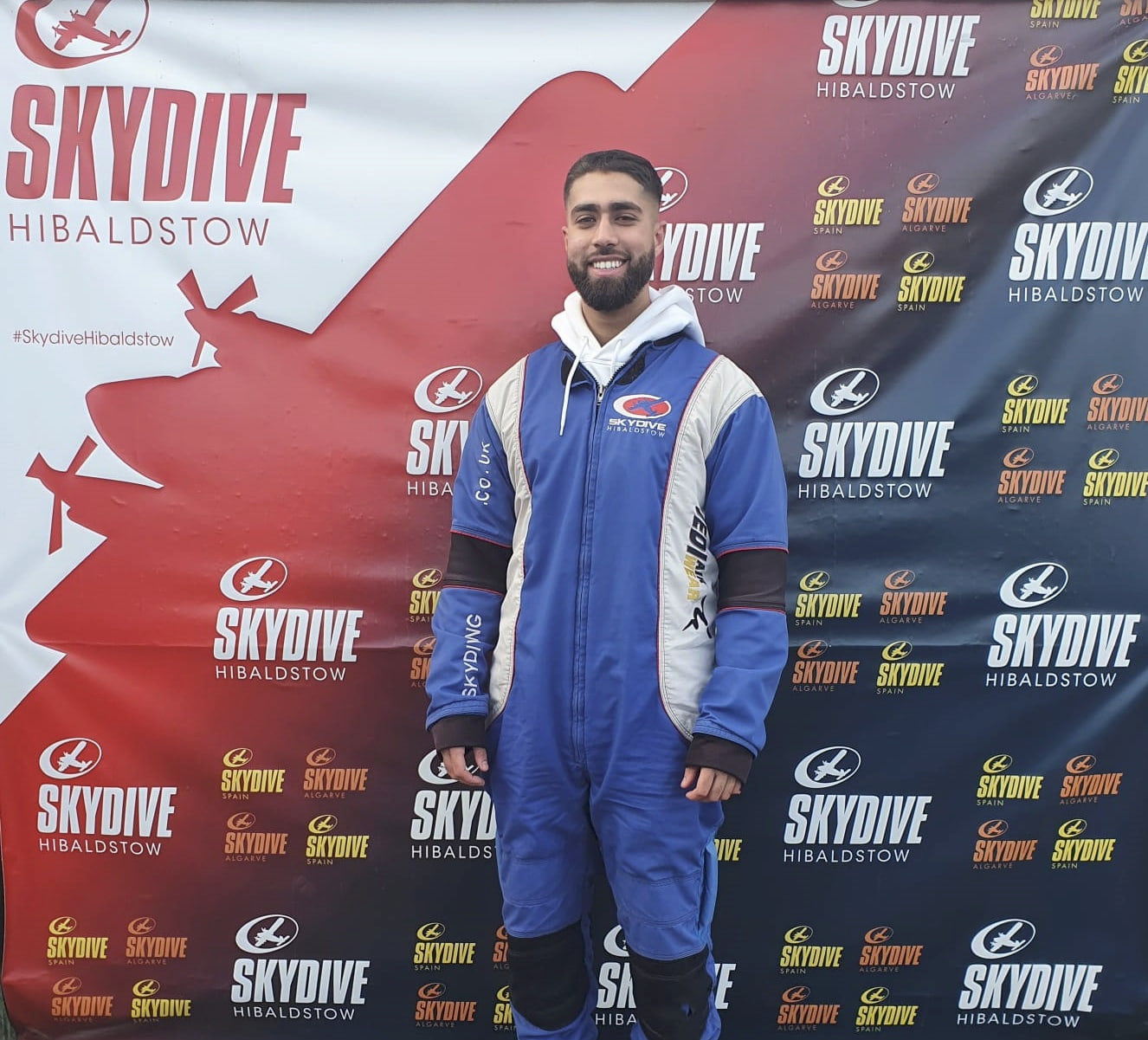 A man in his skydiving uniform after a charity skydive