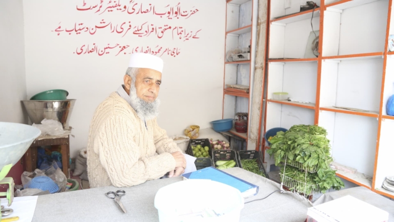 A mid-aged man sat at his stall which was sponsored through Muazzam Foundation's Empowering Communities project