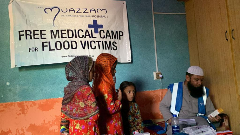 Young children receiving medication at Muazzam Foundation's free medical camp for flood victims as part of their Natural Disaster Relief project.