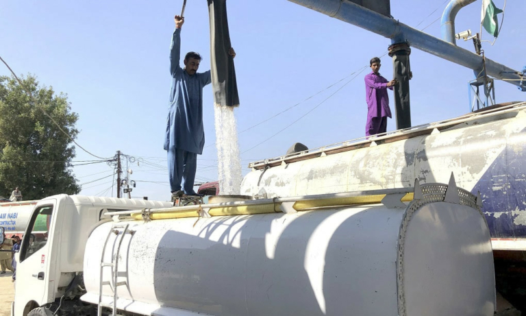 A volunteer filling a water tanker in Pakistan