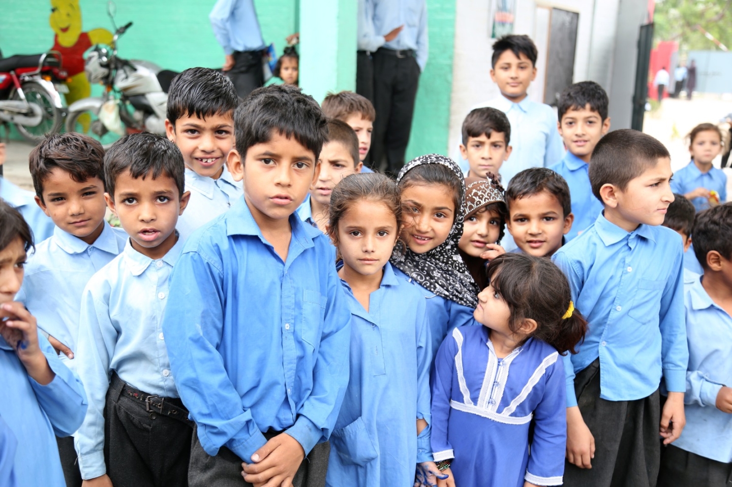 A large group of orphans in Pakistan stood looking into the camera at Muazzam Foundation's sponsor an orphan event