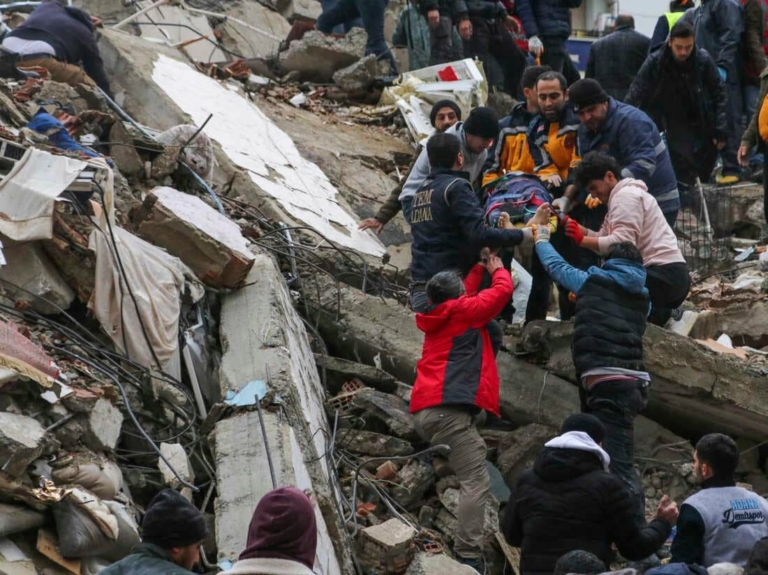 Rescue workers pulling survivors and casualties from the rubble after the earthquake in Turkey and Syria